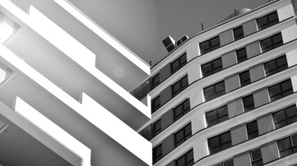 Fototapeta na wymiar Fragment of modern residential apartment with flat buildings exterior. Detail of new luxury house and home complex. Black and white filter.