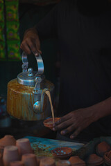 Indian traditionally tea making process in a road side tea stall. 