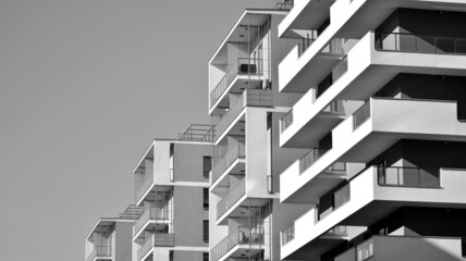 Fragment of modern residential apartment with flat buildings exterior. Detail of new luxury house and home complex. Black and white filter.