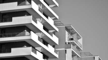 Fragment of modern residential apartment with flat buildings exterior. Detail of new luxury house and home complex. Black and white filter.