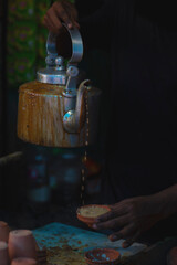 Indian traditionally tea making process in a road side tea stall. 