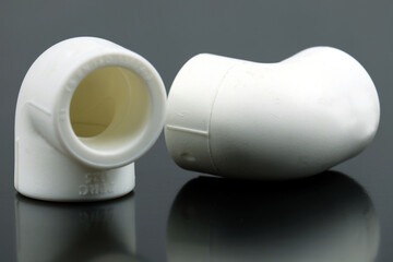 plastic pipe elbow on black background