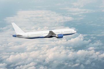 Passenger plane flying in the clouds, air travel concept.