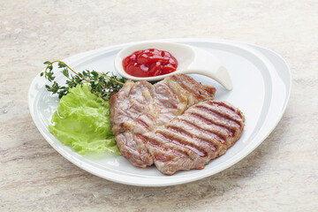 Grilled pork neck steak with ketchup