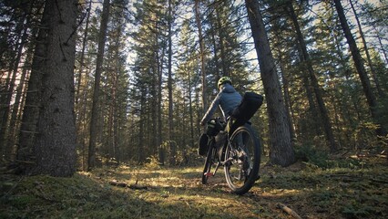 The woman travel on mixed terrain cycle touring with bike bikepacking outdoor. The traveler journey...