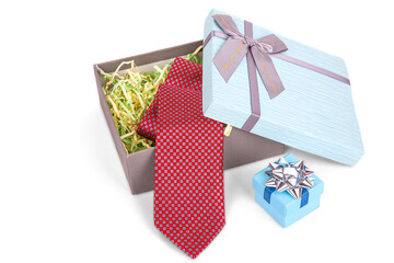 a slightly opened gift box with a bow, with a red tie inside