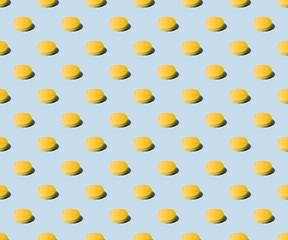 Yellow pills on a blue background. Seamless pattern for the background. Medical pharmacy bright...