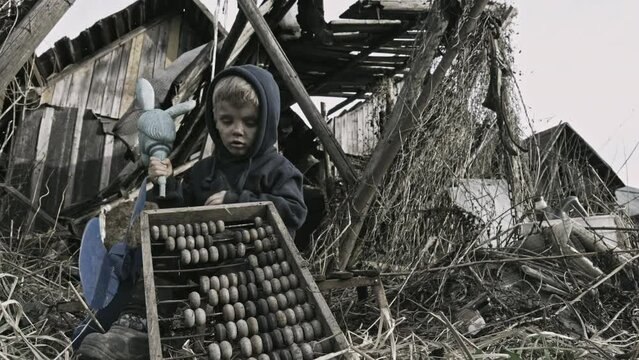 Child playing war in ruins