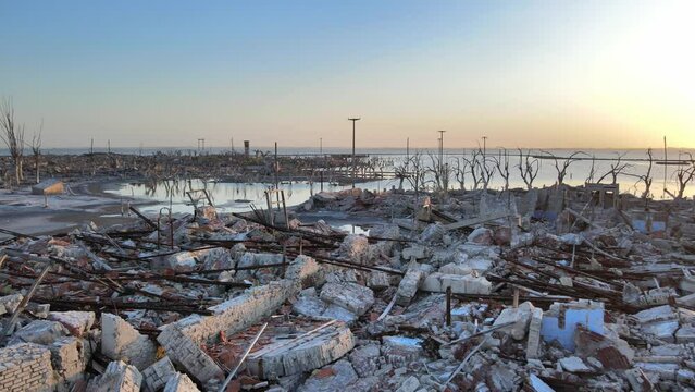 Slow pan shot capturing once-thriving argentine spa town of villa epecuen, flood wiped out the town with broken ruins and fragments of houses, sunset view.