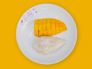 High angle view, Nam Dok Mai mango (knife peeling), and glutinous rice, topped with coconut milk....