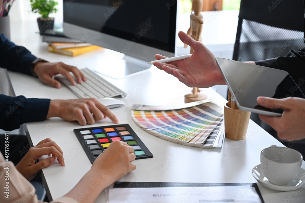 Poster group of graphic designers brainstorming and working on new project together.