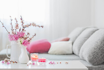 spring pink flowers in vase in white interior - Powered by Adobe