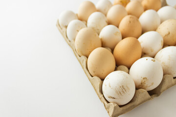 Cardboard tray with natural farm white and brown chicken eggs. Preparation for the Easter holiday.