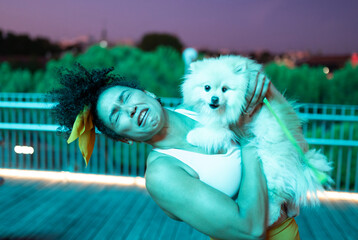 woman with a disgusted face when sucked by her dog, small dog licks women face