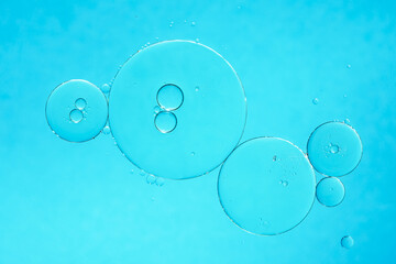 Oil and water bubbles on blue background. Abstract oil bubbles background.