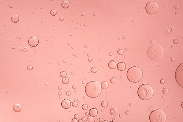 Abstract pink oil bubbles background. Cosmetic liquid beauty product.