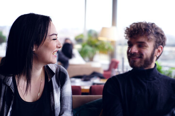 couple in a cafe smiling and talking