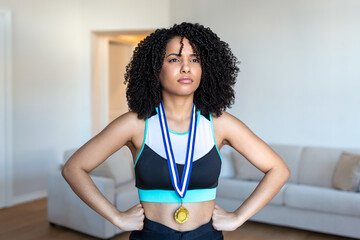 Cropped portrait of an attractive young female athlete posing with her gold medal out