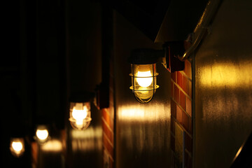Ship lights lined up on the wall illuminating the stairs to the basement