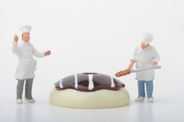 miniature figurines of cooks with some giant confectionery stuff