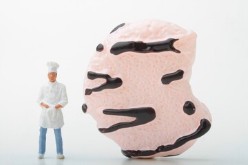 miniature figurine of a chef with a huge biscuit