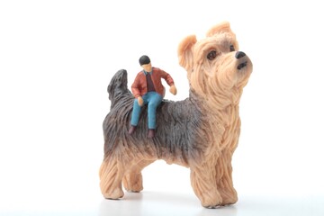 miniature figurine of a man sitting on a giant dog
