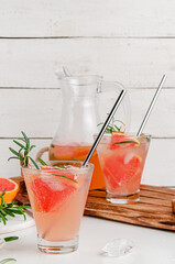 Iced grapefruit drink with rosemary. Copy space
