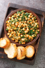 Espinacas con Garbanzos Andalusian Spinach and Chickpeas closeup in the plate on the table. Vertical top view from above