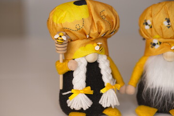 Fototapeta premium dwarf, elf, yellow elf, dwarf with a spoon for honey