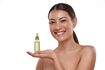 Fototapeta premium It helps keep your face fresh for longer. Shot of a beautiful young woman holding up a bottle of face mist.