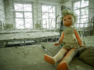 Broken doll sit inside devasted and deserted interior, Chernobyl nuclear zone, Ukraine