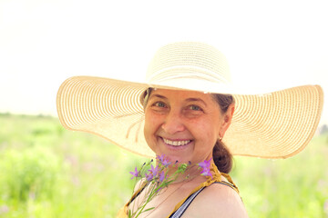   Portrait of   mature woman in   dress in   field .