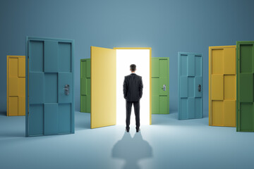 Man standing in front of abstract colorful puzzle door in interior. Future, choice, success, direction, opportunity and solution concept. - obrazy, fototapety, plakaty