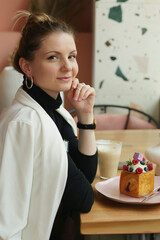 young blond business woman on lunch in cafe drinking latte coffee close up photo