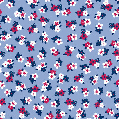 Fototapeta na wymiar Small ditsy floral pattern in red white blue