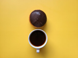 Morning with cup of hot coffee and sweet donuts on yellow background. Top view, copy space, mockup. Flat lay. Food and drinks. Spring holidays. 