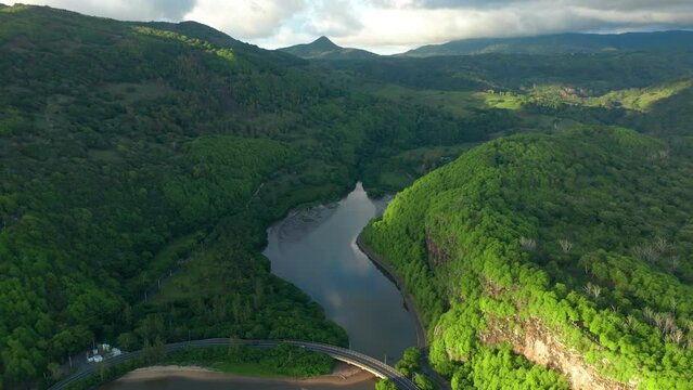 Maconde beach bathing in beautiful sunlight with amazing surrounding landscape. Aerial shot of beautiful Mauritius scenery.