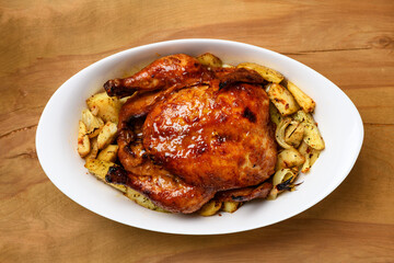 fried chicken meat and roasted potatoes, tasty food on a wooden background