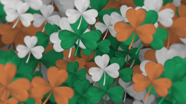 Saint Patrick's Day background: gently moving shamrocks and particles in the green, white and gold colors of the Irish tricolor flag. This textured motion background is full HD and a seamless loop.