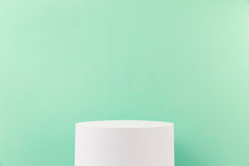 product stand on white base on green ground