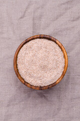 Brown psyllium in a wooden bowl