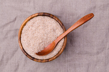 Brown psyllium in a wooden bowl