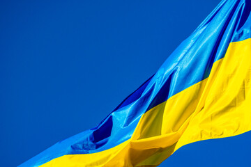 Blue and yellow Ukrainian flag waving on windy day