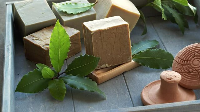 Natural organic Aleppo soaps in wooden box. Table spin.