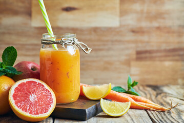 Fruit juice served in jar. Various fresh fruit juice citrus apple and carrots served in jar on...
