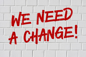 Graffiti on a brick wall - We need a change
