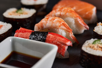 Sushi variety on a black stone