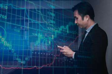 Double exposure business man wearing suite looking at diagram graph investment in business have detail smart phone on hand with diagram graph investment background.
