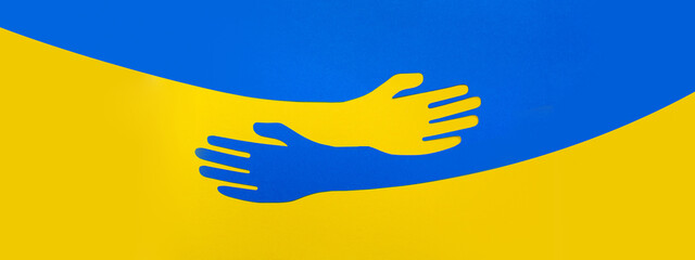 Fototapeta Support for Ukraine. Panoramatic format. Embrace icon, hugging arms in colors of Ukraine. War attack of Russia. Papercut, hands hug template. Care love and charity symbol, hand support. Panorama photo obraz
