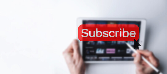 Subscribe button. Online video subscription red button. Internet service on laptop digital tablet blured banner background. Visual contents concept. Social networking service.